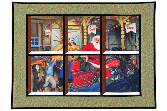 Quilted window-style wall hanging depicting Santa on a motorcycle named Comet with elves packing it with toys beneath colorful Christmas lights, framed by a green border with candy canes.